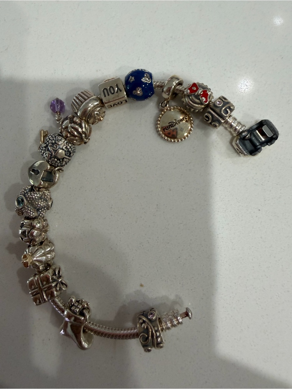 Pandora Sterling Silver Charm Bracelet with Some Gold in charms.